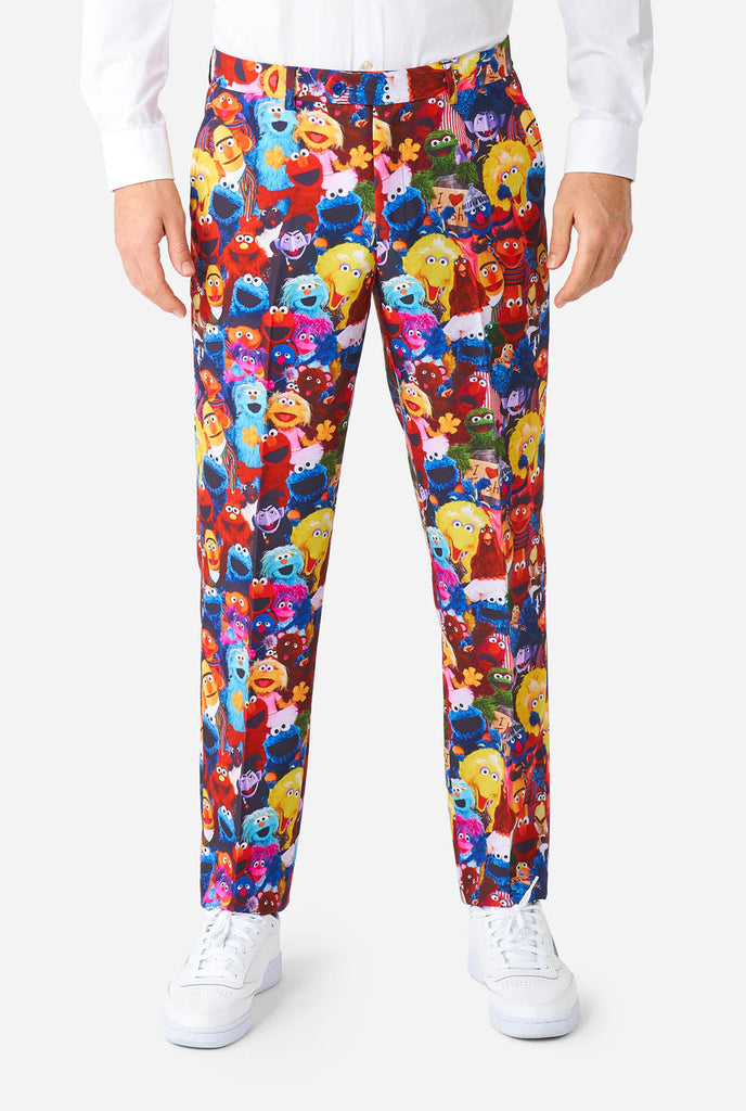 Man wearing men's suit with Sesame street characters print, pants view