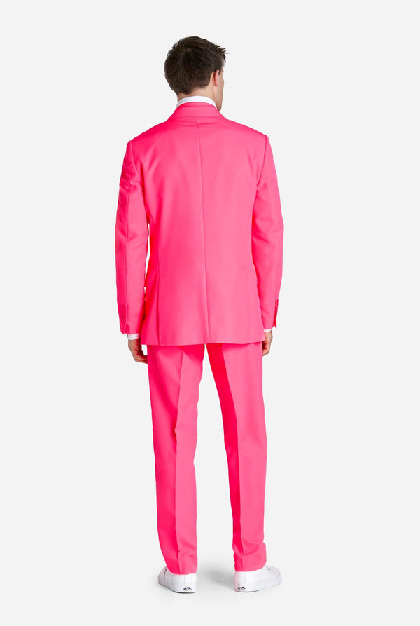 Man wearing neon pink men's suit, view from the back