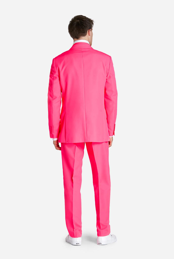 Man wearing neon pink men's suit, view from the back