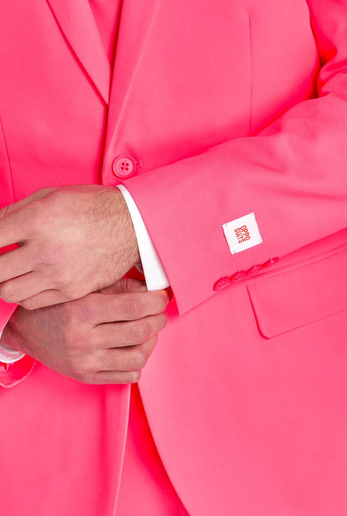 Man wearing neon pink men's suit, close up